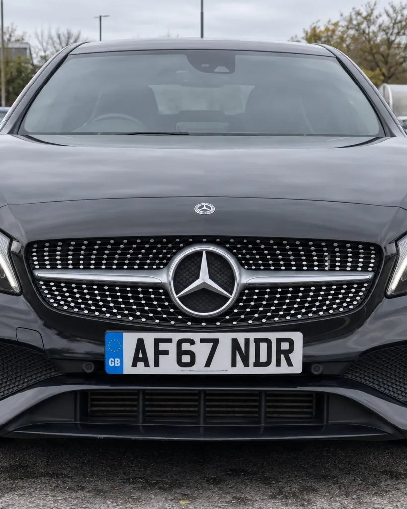 Front of a black Mercedes A-Class with its number plate in view